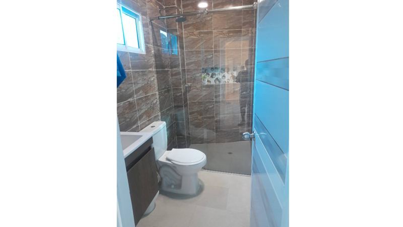 Modern bathroom with spacious shower and marble finishes